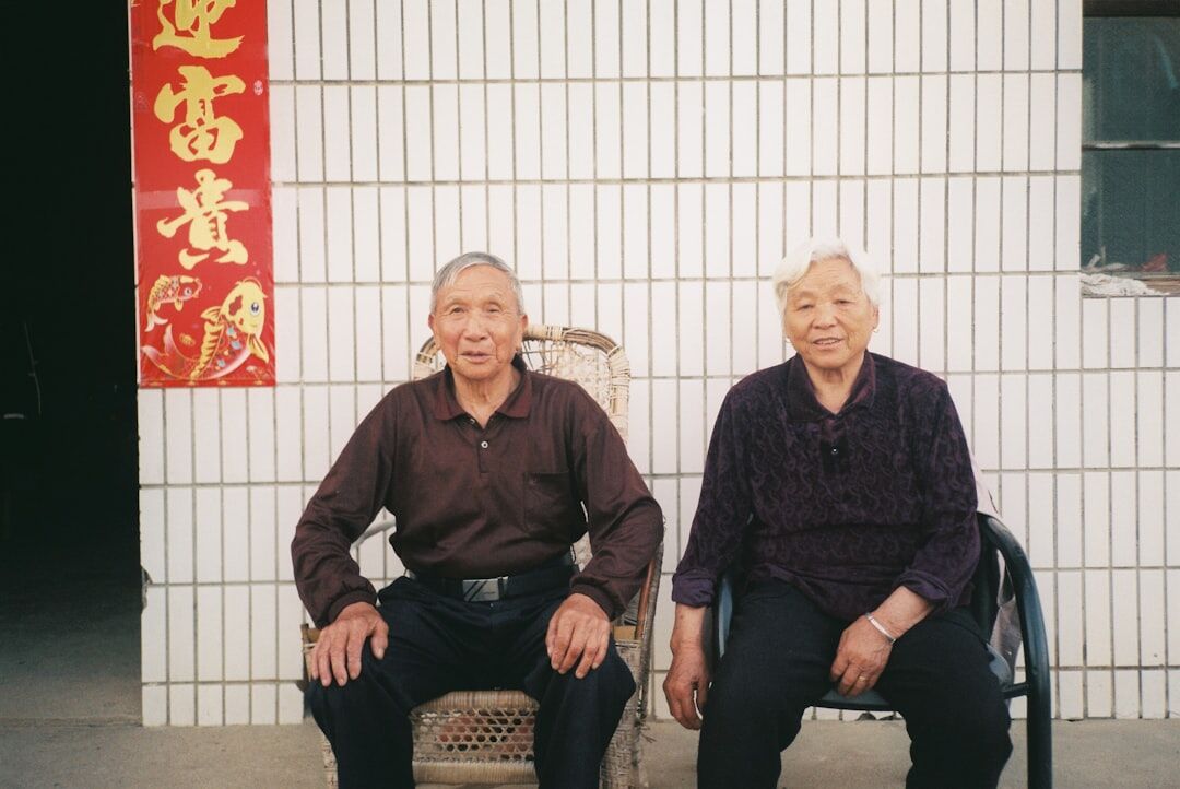 Elderly Danish couple sitting together at home by a window